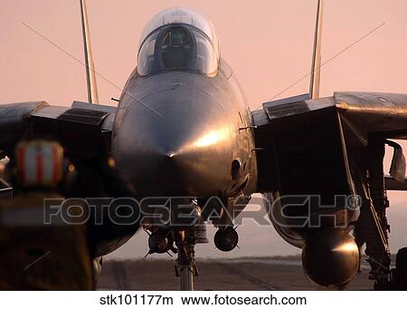 An F-14 Tomcat is directed to the steam-powered catapult aboard USS Theodore Roosevelt. View Large Photo Image Picture - An F-14 Tomcat is directed to the steam-powered catapult aboard USS Theodore Roosevelt.. Fotosearch