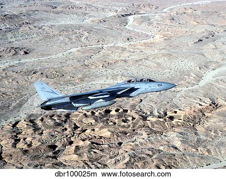 Picture - An F-14A Tomcat makes a low pass above the Southern California desert.. Fotosearch