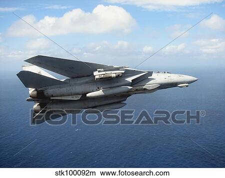 An F-14D Tomcat banks with its tailhook lowered in preparation for landing. View Large Photo Image Picture - An F-14D Tomcat banks with its tailhook lowered in preparation for landing.. Fotosearch