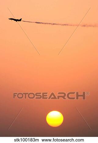 An F-14D Tomcat dumps fuel prior to a sunset landing. View Large Photo Image Picture - An F-14D Tomcat dumps fuel prior to a sunset landing.. Fotosearch