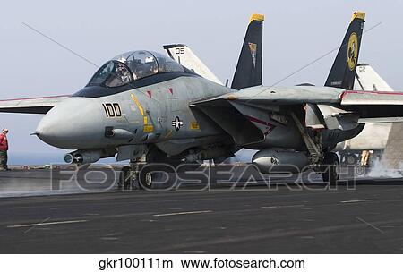 An F-14D Tomcat launches off the flight deck of USS Theodore Roosevelt. View Large Photo Image Picture - An F-14D Tomcat launches off the flight deck of USS Theodore Roosevelt.. Fotosearch