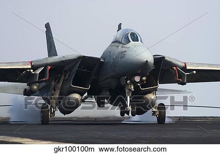 An F-14D Tomcat makes an arrested landing on the flight deck of USS Theodore Roosevelt. View Large Photo Image Picture - An F-14D Tomcat makes an arrested landing on the flight deck of USS Theodore Roosevelt.. Fotosearch