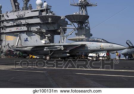 An F-14D Tomcat on the flight deck of USS Theodore Roosevelt. View Large Photo Image Picture - An F-14D Tomcat on the flight deck of USS Theodore Roosevelt.. Fotosearch