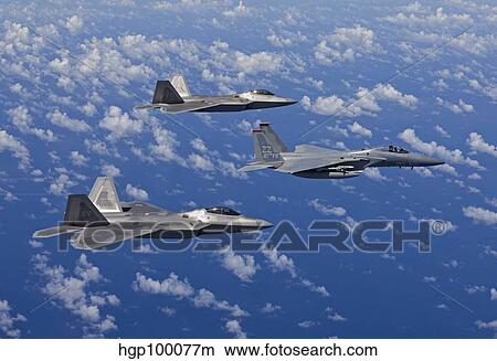 An F-15 Eagle and two F-22 Raptors fly in formation over Japan. View Large Photo Image Picture - An F-15 Eagle and two F-22 Raptors fly in formation over Japan.. Fotosearch