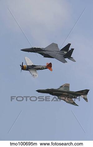 An F-15 Eagle, P-47 Thunderbolt, and F-4 Phantom fly a heritage flight. View Large Photo Image Picture - An F-15 Eagle, P-47 Thunderbolt, and F-4 Phantom fly a heritage flight.. Fotosearch