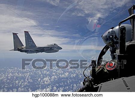 An F-15 Eagle pilot flies in formation with his wingman. View Large Photo Image Picture - An F-15 Eagle pilot flies in formation with his wingman.. Fotosearch