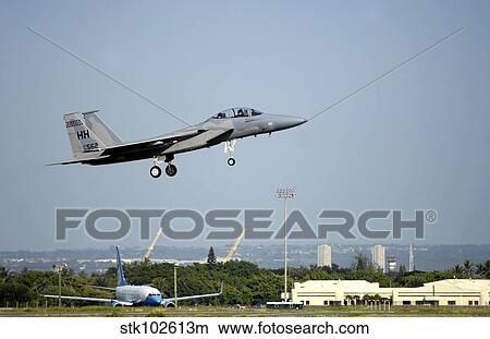 An F-15A Eagle returns to Hickam Air Force Base. View Large Photo Image Picture - An F-15A Eagle returns to Hickam Air Force Base.. Fotosearch