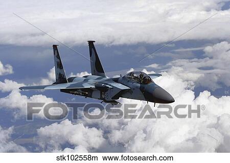 An F-15C Aggressor flies over a mountain range. View Large Photo Image Picture - An F-15C Aggressor flies over a mountain range.. Fotosearch