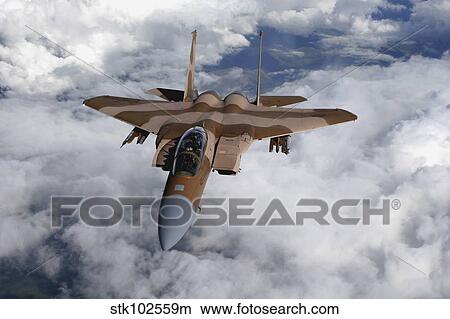 An F-15C Aggressor flies over a mountain range. View Large Photo Image Picture - An F-15C Aggressor flies over a mountain range.. Fotosearch