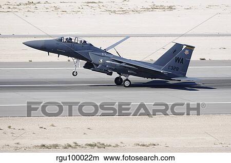 An F-15C Eagle landing on the runway at Nellis Air Force Base. View Large Photo Image Picture - An F-15C Eagle landing on the runway at Nellis Air Force Base.. Fotosearch