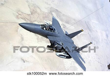 An F-15E Strike Eagle turns away after recieving fuel. View Large Photo Image Picture - An F-15E Strike Eagle turns away after recieving fuel.. Fotosearch