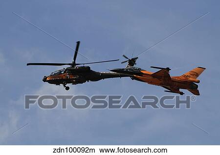 An F-16 Falcon and AH-64 Apache from the Royal Netherlands Air Force. View Large Photo Image Picture - An F-16 Falcon and AH-64 Apache from the Royal Netherlands Air Force.. Fotosearch