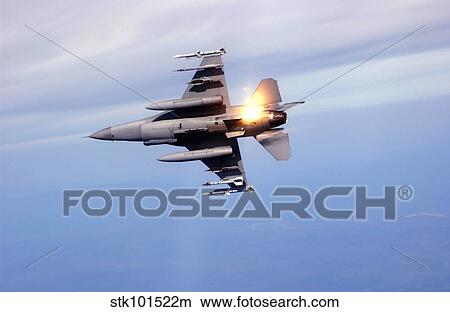 An F-16 Fighting Falcon drops flares while performing manuevers. View Large Photo Image Picture - An F-16 Fighting Falcon drops flares while performing manuevers.. Fotosearch