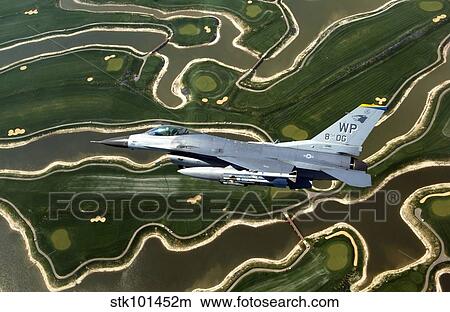 Picture - An F-16 Fighting Falcon flies near base.. Fotosearch