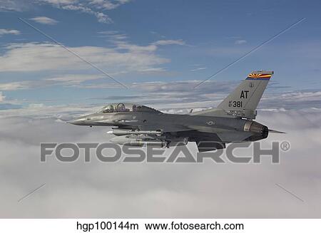 An F-16 Fighting Falcon flies with an AGM-65 Maverick missile. View Large Photo Image Picture - An F-16 Fighting Falcon flies with an AGM-65 Maverick missile.. Fotosearch