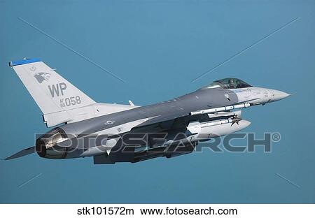 An F-16 Fighting Falcon in flight. View Large Photo Image Picture - An F-16 Fighting Falcon in flight.. Fotosearch