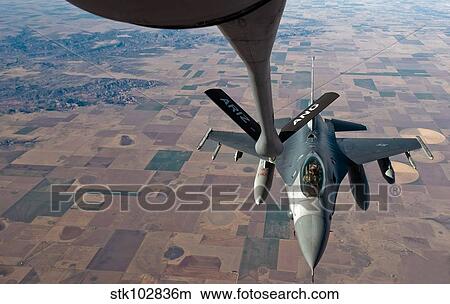 An F-16 Fighting Falcon moves into place to receive fuel from a KC-135 Stratotanker. View Large Photo Image Picture - An F-16 Fighting Falcon moves into place to receive fuel from a KC-135 Stratotanker.. Fotosearch