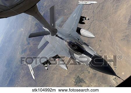 An F-16 Fighting Falcon receives fuel from a KC-135 Stratotanker. View Large Photo Image Picture - An F-16 Fighting Falcon receives fuel from a KC-135 Stratotanker.. Fotosearch