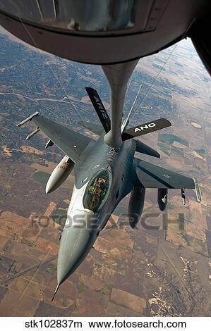 An F-16 Fighting Falcon receiving fuel from a KC-135 Stratotanker. View Large Photo Image Picture - An F-16 Fighting Falcon receiving fuel from a KC-135 Stratotanker.. Fotosearch