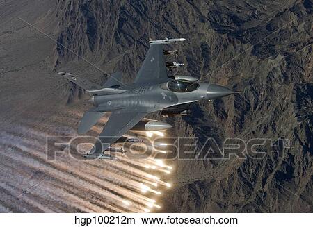 An F-16 Fighting Falcon releases flares during a training mission. View Large Photo Image Picture - An F-16 Fighting Falcon releases flares during a training mission.. Fotosearch