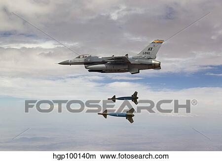 An F-16 Fighting Falcon releases two GBU-24 laser guided bombs. View Large Photo Image Picture - An F-16 Fighting Falcon releases two GBU-24 laser guided bombs.. Fotosearch