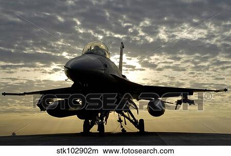 Picture - An F-16 Fighting Falcon sits tethered to the hot cargo pad at Joint Base Balad, Iraq.. Fotosearch