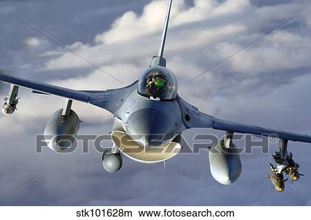 An F-16 Fighting Falcon soars through the sky. View Large Photo Image Picture - An F-16 Fighting Falcon soars through the sky.. Fotosearch