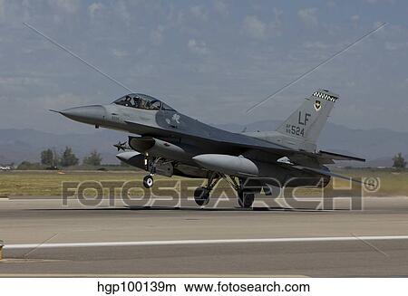 An F-16 Fighting Falcon takes off from Luke Air Force Base, Arizona. View Large Photo Image Picture - An F-16 Fighting Falcon takes off from Luke Air Force Base, Arizona.. Fotosearch