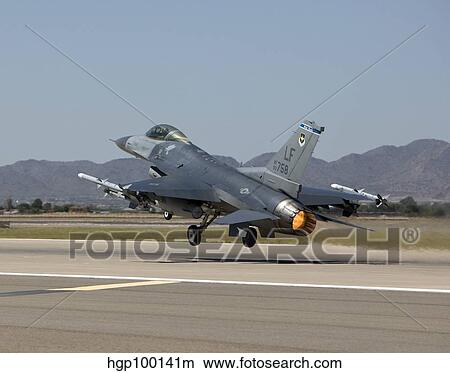 An F-16 Fighting Falcon takes off from Luke Air Force Base, Arizona. View Large Photo Image Picture - An F-16 Fighting Falcon takes off from Luke Air Force Base, Arizona.. Fotosearch