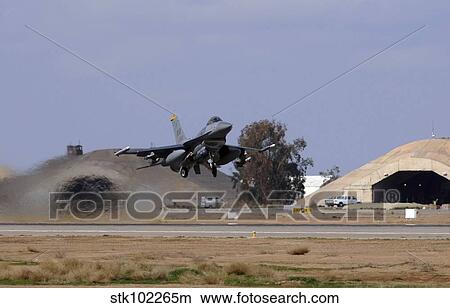 An F-16 Fighting Falcon takes off from Balad Air Base, Iraq. View Large Photo Image Picture - An F-16 Fighting Falcon takes off from Balad Air Base, Iraq.. Fotosearch