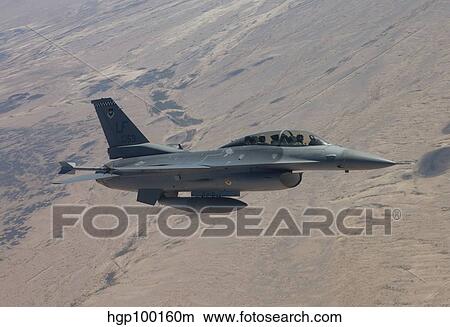 An F-16 maneuvers during a training mission over Arizona. View Large Photo Image Picture - An F-16 maneuvers during a training mission over Arizona.. Fotosearch