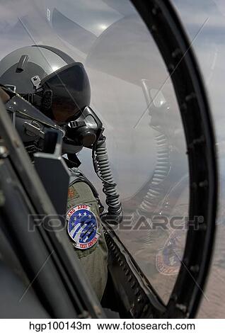 An F-16 pilot checks the position of his wingman during a test mission. View Large Photo Image Picture - An F-16 pilot checks the position of his wingman during a test mission.. Fotosearch