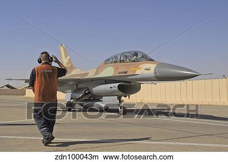 An F-16B Netz of the Israeli Air Force gets the take off sign from the ground crew. View Large Photo Image Picture - An F-16B Netz of the Israeli Air Force gets the take off sign from the ground crew.. Fotosearch