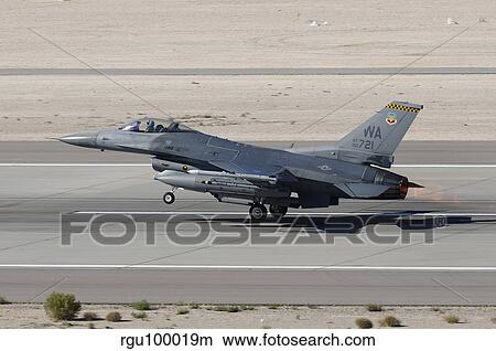 An F-16C Fighting Falcon taking off from Nellis Air Force Base. View Large Photo Image Picture - An F-16C Fighting Falcon taking off from Nellis Air Force Base.. Fotosearch