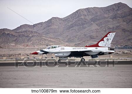 An F-16C Thunderbird sits on the runway at Nellis Air Force Base, Nevada. View Large Photo Image Picture - An F-16C Thunderbird sits on the runway at Nellis Air Force Base, Nevada.. Fotosearch