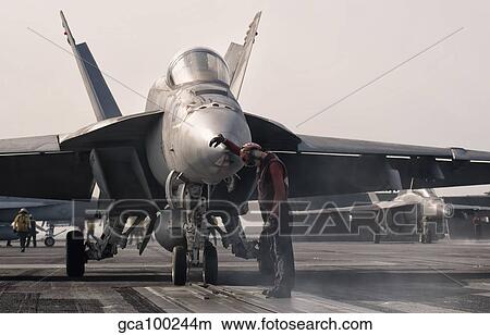 An F/-18E Super Hornet is guided into catapult aboard USS George H. W. Bush. View Large Photo Image Picture - An F/-18E Super Hornet is guided into catapult aboard USS George H. W. Bush.. Fotosearch