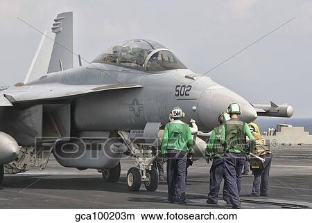 An F/-18F Super Hornet is guided into catapult aboard USS George H. W. Bush. View Large Photo Image Picture - An F/-18F Super Hornet is guided into catapult aboard USS George H. W. Bush.. Fotosearch