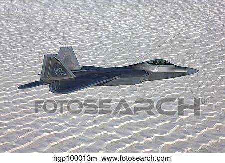 An F-22 Raptor flies around Southern New Mexico. View Large Photo Image Picture - An F-22 Raptor flies around Southern New Mexico.. Fotosearch