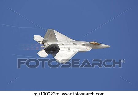 An F-22 Raptor in flight over Nellis Air Force Base, Nevada. View Large Photo Image Picture - An F-22 Raptor in flight over Nellis Air Force Base, Nevada.. Fotosearch