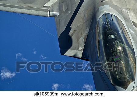 An F-22 Raptor in flight over the Hawaiian Islands. View Large Photo Image Picture - An F-22 Raptor in flight over the Hawaiian Islands.. Fotosearch
