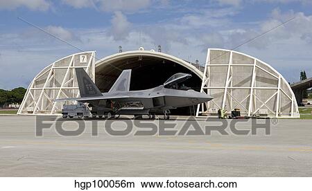 Picture - An F-22 Raptor parked in front of a hardened aircraft shelter at Kadena Air Base.. Fotosearch