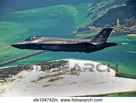 An F-35 Lightning II flies over Destin, Florida. View Large Photo Image Picture - An F-35 Lightning II flies over Destin, Florida.. Fotosearch