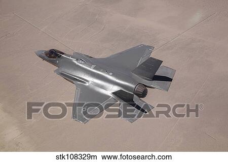 An F-35 Lightning II flies over Edwards Air Force Base, California. View Large Photo Image Picture - An F-35 Lightning II flies over Edwards Air Force Base, California.. Fotosearch