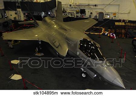 An F-35B Lightning II is secured in the hangar bay aboard USS Wasp. View Large Photo Image Picture - An F-35B Lightning II is secured in the hangar bay aboard USS Wasp.. Fotosearch