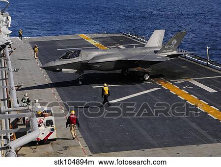 An F-35B Lightning II makes a vertical landing on the flight deck of USS Wasp. View Large Photo Image Picture - An F-35B Lightning II makes a vertical landing on the flight deck of USS Wasp.. Fotosearch