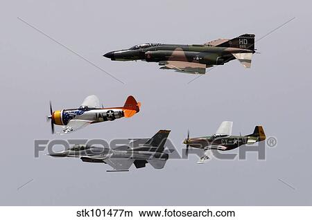 An F-4 Phantom, P-47 Thunderbolt, F-16 Fighting Falcon and P-51 Mustang fly in a heritage flight. View Large Photo Image Picture - An F-4 Phantom, P-47 Thunderbolt, F-16 Fighting Falcon and P-51 Mustang fly in a heritage flight.. Fotosearch