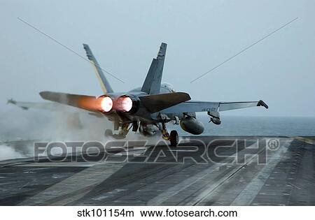 An F/A-18 Hornet launches from the flight deck aboard USS Theodore Roosevelt. View Large Photo Image Picture - An F/A-18 Hornet launches from the flight deck aboard USS Theodore Roosevelt.. Fotosearch