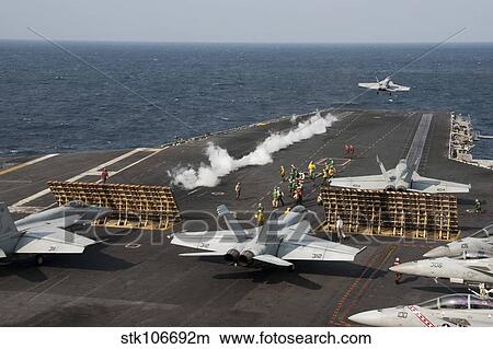 An F/A-18 Hornet launches from the aircraft carrier USS George Washington. View Large Photo Image Picture - An F/A-18 Hornet launches from the aircraft carrier USS George Washington.. Fotosearch