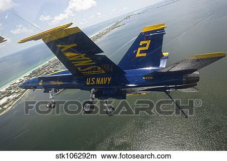 An F/A-18 Hornet of the Blue Angels in flight over Pensacola Beach, Florida. View Large Photo Image Picture - An F/A-18 Hornet of the Blue Angels in flight over Pensacola Beach, Florida.. Fotosearch