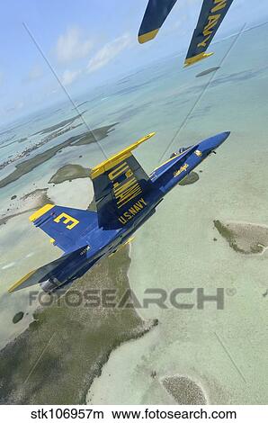 An F/A-18 Hornet of the Blue Angels flies over the Florida Keys. View Large Photo Image Picture - An F/A-18 Hornet of the Blue Angels flies over the Florida Keys.. Fotosearch